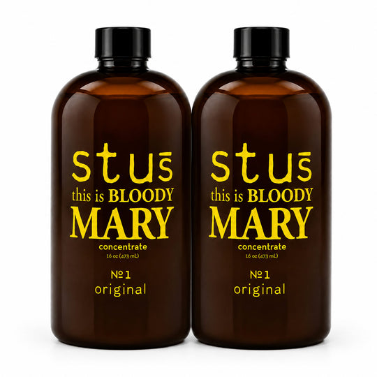 Two amber glass bottles with black caps, featuring yellow text that reads 'stus this is BLOODY MARY' and 'concentrate' on a white background.