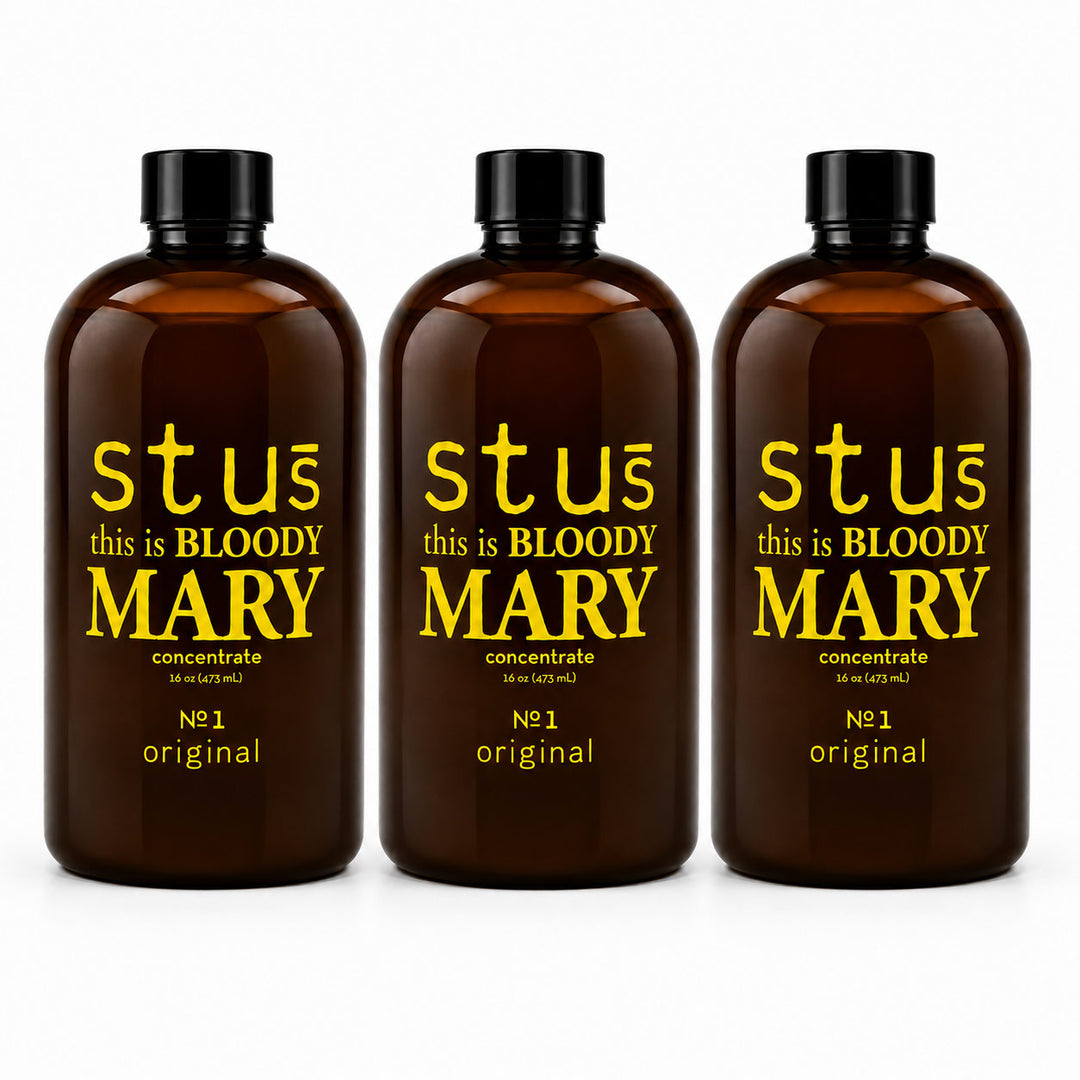 Three amber glass bottles with black caps and yellow text reading 'stuć this is BLOODY MARY concentrate' and 'Nċ1 original', shown on a white background.