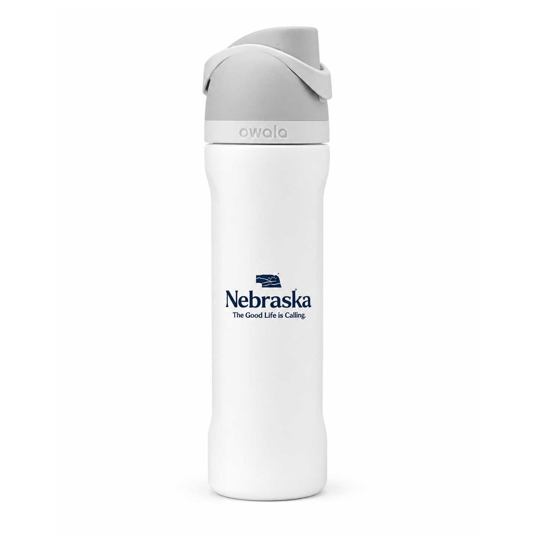 A white Owala insulated water bottle with a gray lid and a navy blue Nebraska logo printed on the front, set against a plain white background.