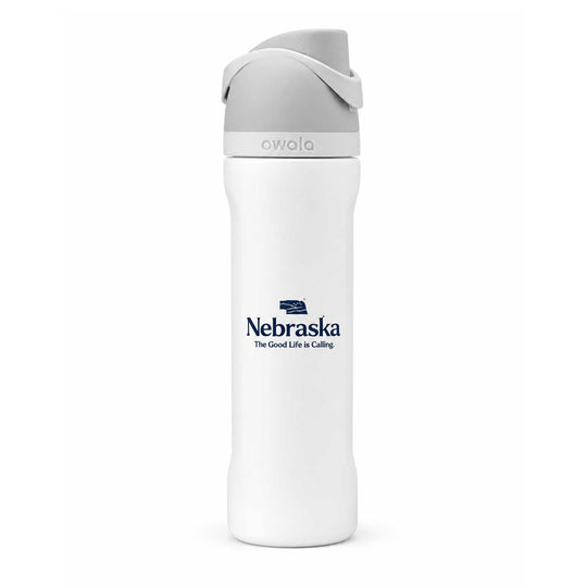 A white Owala insulated water bottle with a gray lid and a navy blue Nebraska logo printed on the front, set against a plain white background.
