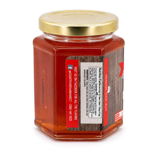 Jar of jelly with a gold lid on a white background