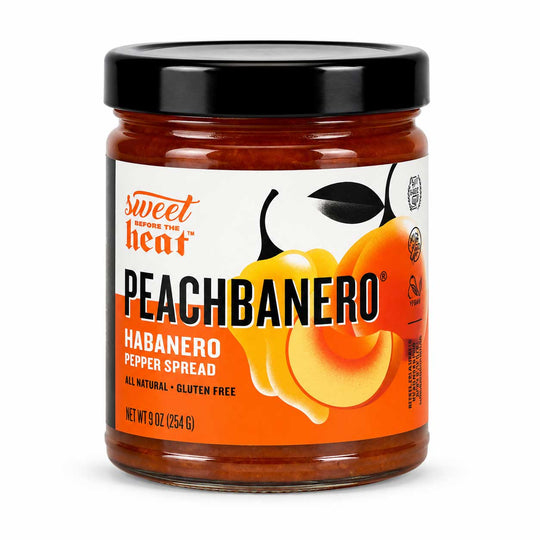 A glass jar of Sweetener's Heat Peachbanero Habanero Pepper Spread with a black lid and a white and orange label featuring a peach and habanero pepper illustration.