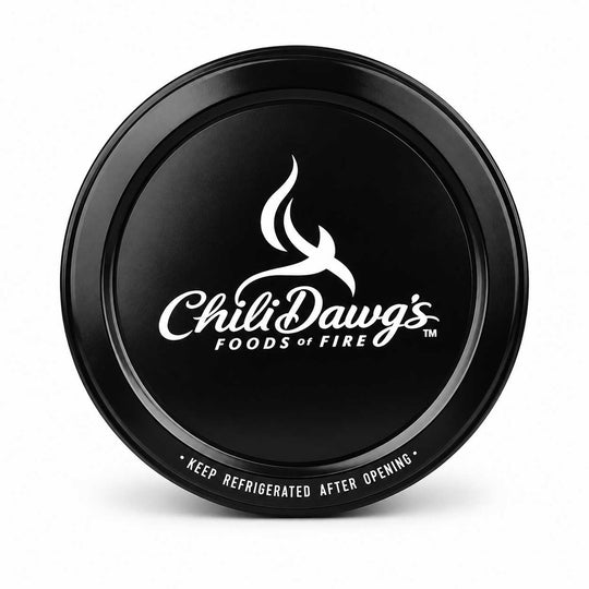 A round black metal can lid featuring the white Chili Dawg's Foods of Fire logo and branding, shown on a clean white background.