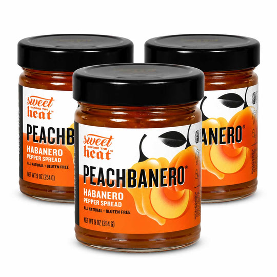 Three glass jars of Sweet Heat Peachbanero Habanero Pepper Spread arranged in a triangle on a white background.