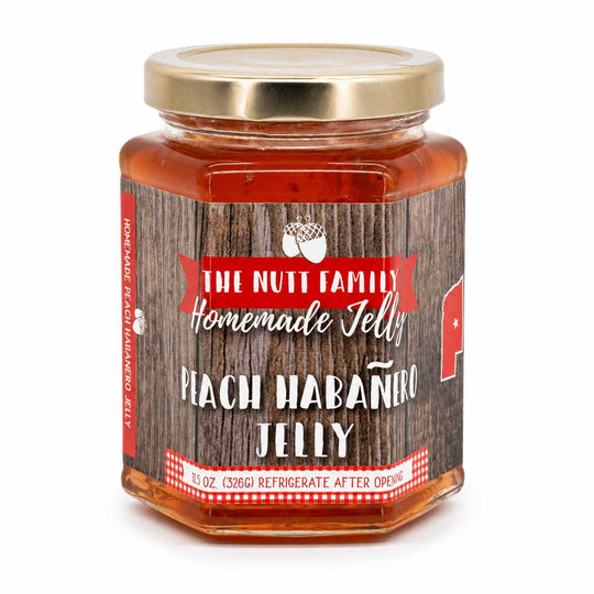 Jar of Peach Habanero Jelly with a wooden-textured label on a white background
