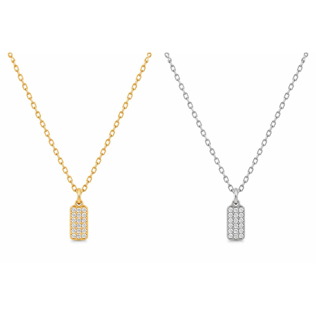 Two rectangular dog-tag style necklaces with pavé-set clear stones, shown side by side on a white background. One necklace has a gold chain and pendant, and the other has a silver chain and pendant.