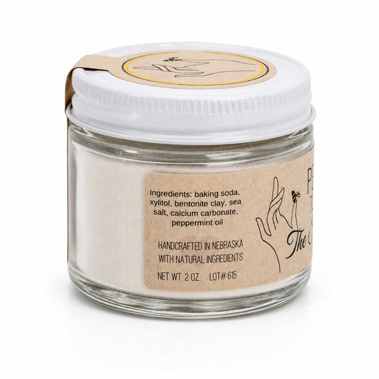 Glass jar with white powder and a label on a white background