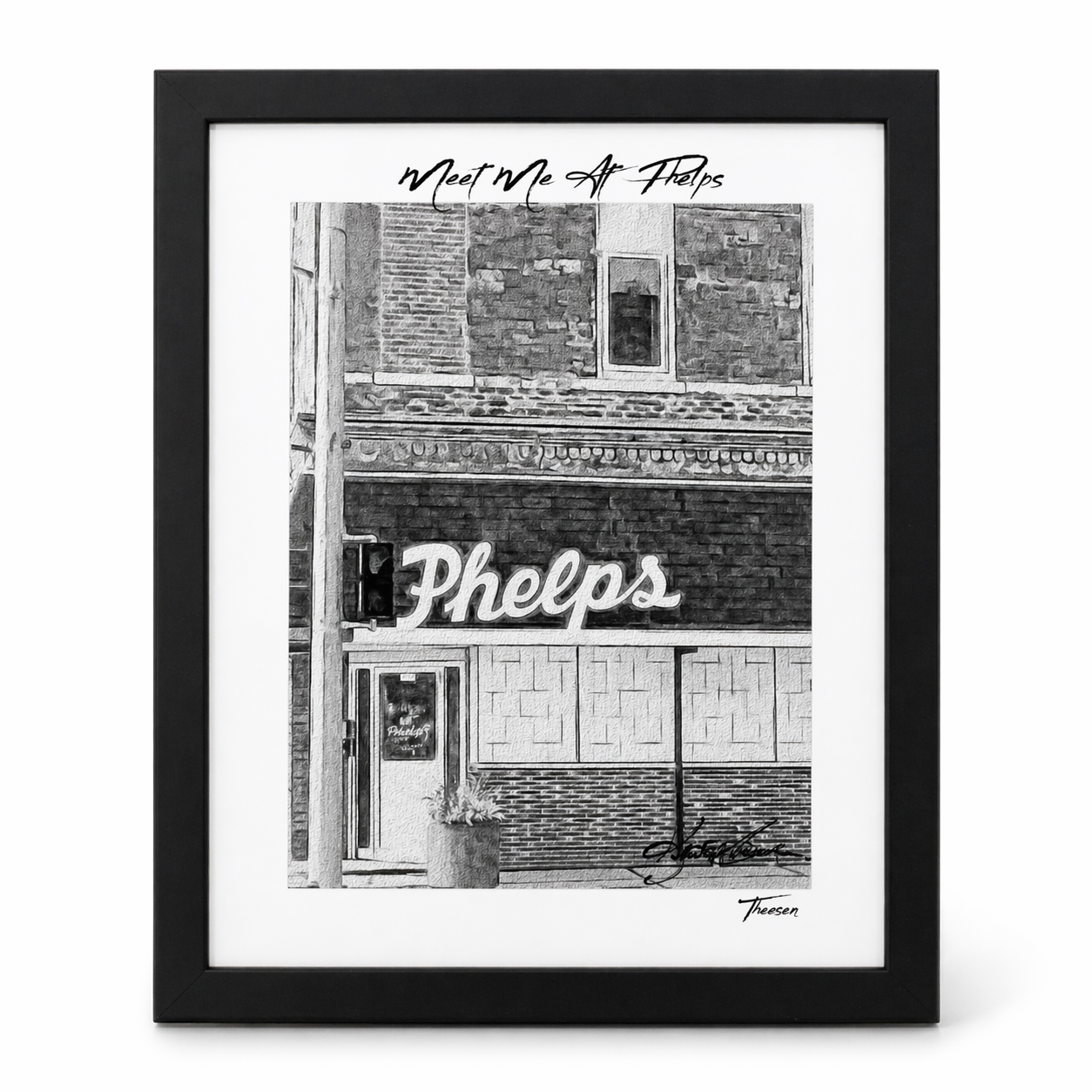 Framed black and white print of a building facade with 'Phelps' sign.