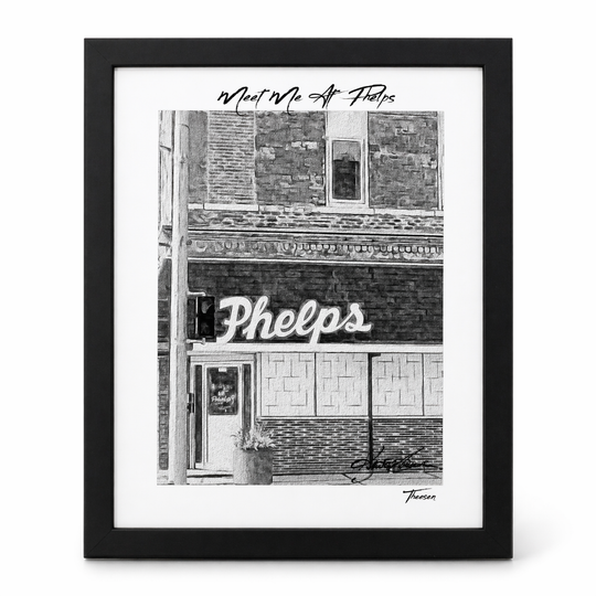 Framed black and white print of a building facade with 'Phelps' sign.