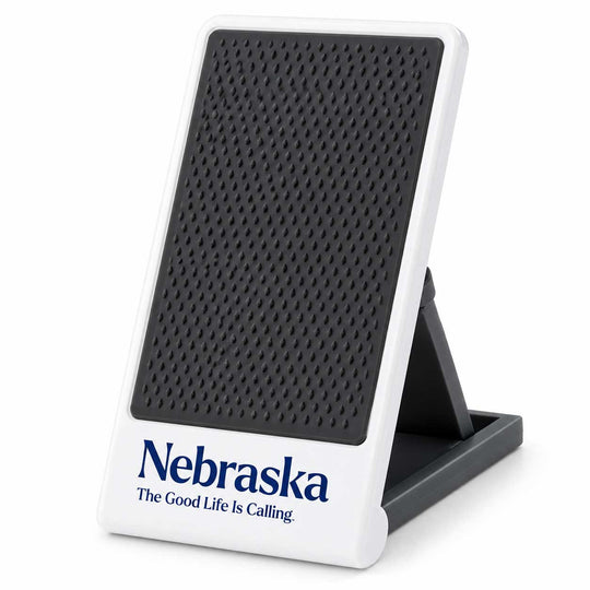 A white and black Nebraska speaker on a stand, featuring a textured black front panel and the blue Nebraska logo with the slogan 'The Good Life Is Calling' on a white base.