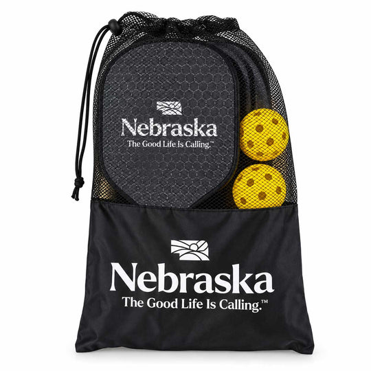 Black mesh drawstring storage bag with Nebraska branding and logo, shown on a white background with two yellow patterned round items visible in the mesh pocket.