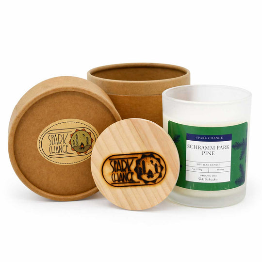 Candle with wooden lid and packaging on a white background