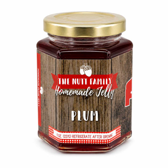 Jar of plum jelly with a wooden-textured label on a white background