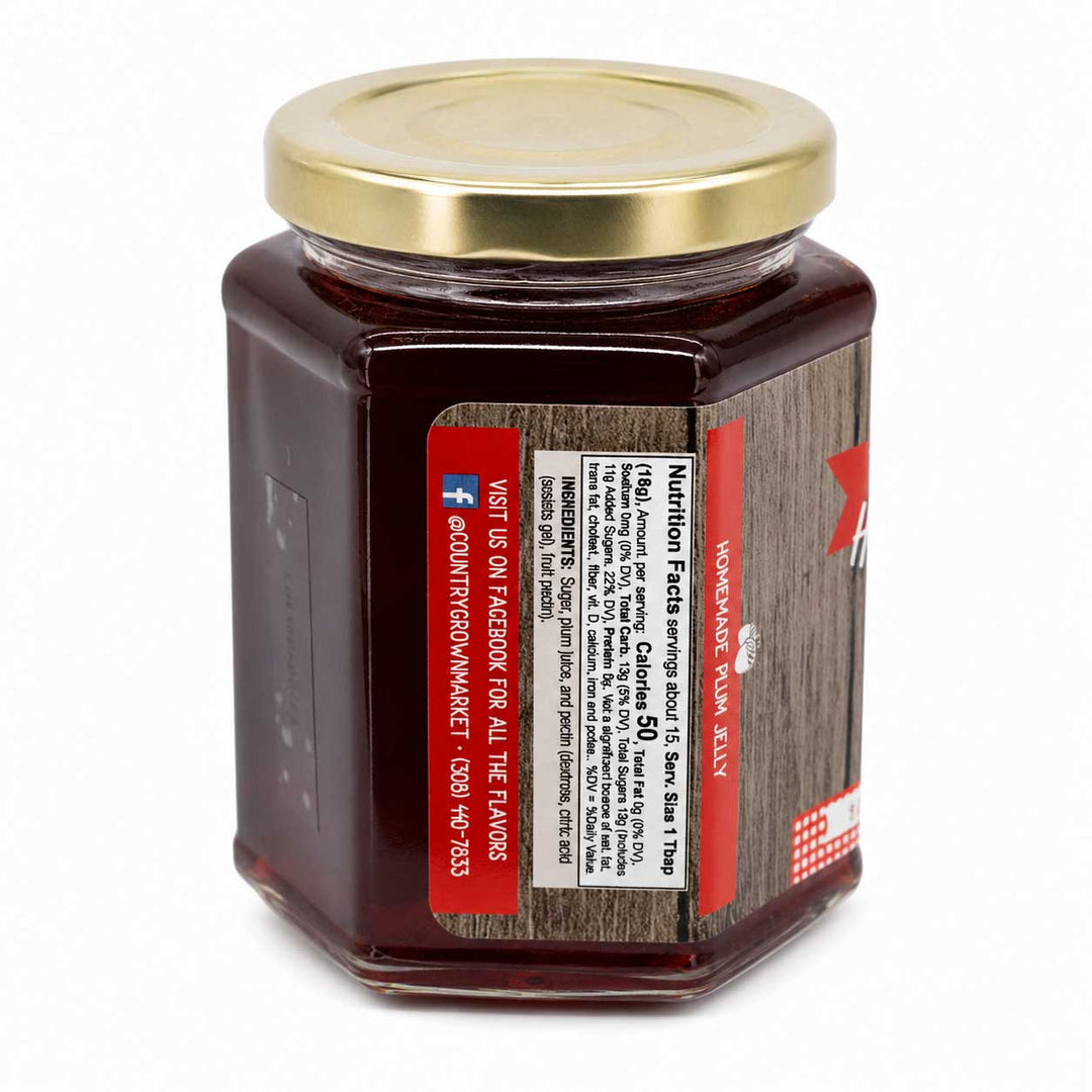 Jar of jelly with a gold lid on a white background
