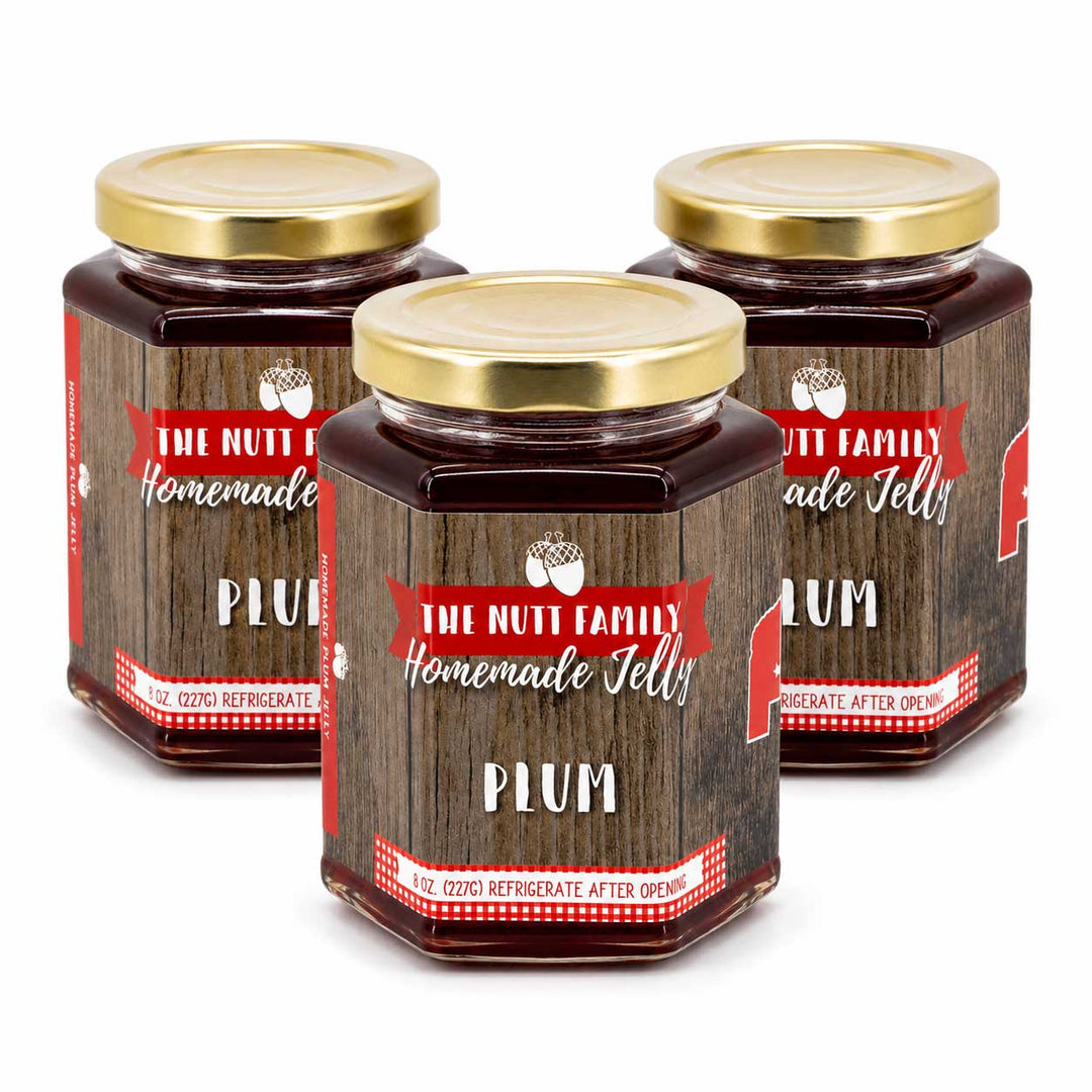 Three jars of 'The Nutt Family Homemade Jelly' plum jelly on a white background