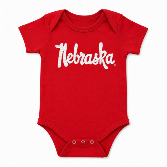 A red short-sleeve baby bodysuit with 'Nebraska' printed in white script across the chest, shown on a plain white background.