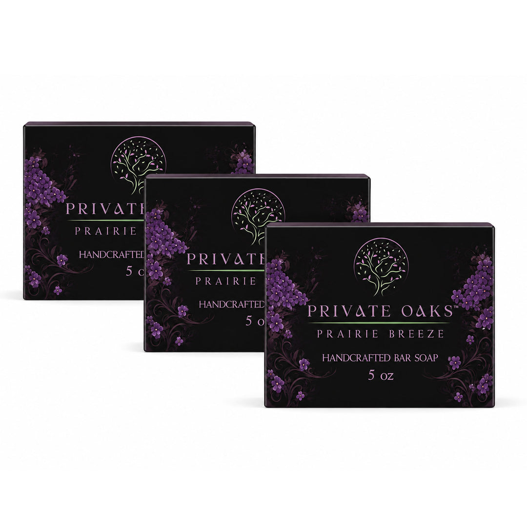 Three black bar soap boxes arranged in a staggered row on a white background. The boxes are labeled 'PRIVATE OAKS PRAIRIE BREEZE HANDCRAFTED BAR SOAP 5 oz' with purple floral illustrations.