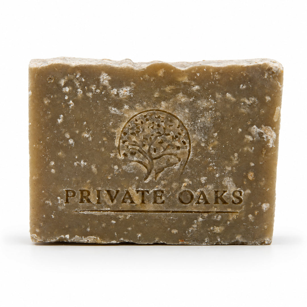 A rectangular bar of handmade soap in a warm brownish-tan color with white speckles, embossed with a tree logo and the brand name 'PRIVATE OAKS' on a white background.