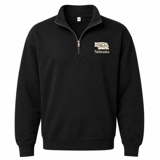 A black long-sleeve quarter-zip sweatshirt with a mock neck collar, featuring a beige and white Nebraska Cornhuskers logo embroidered on the left chest, displayed on a clean white background.