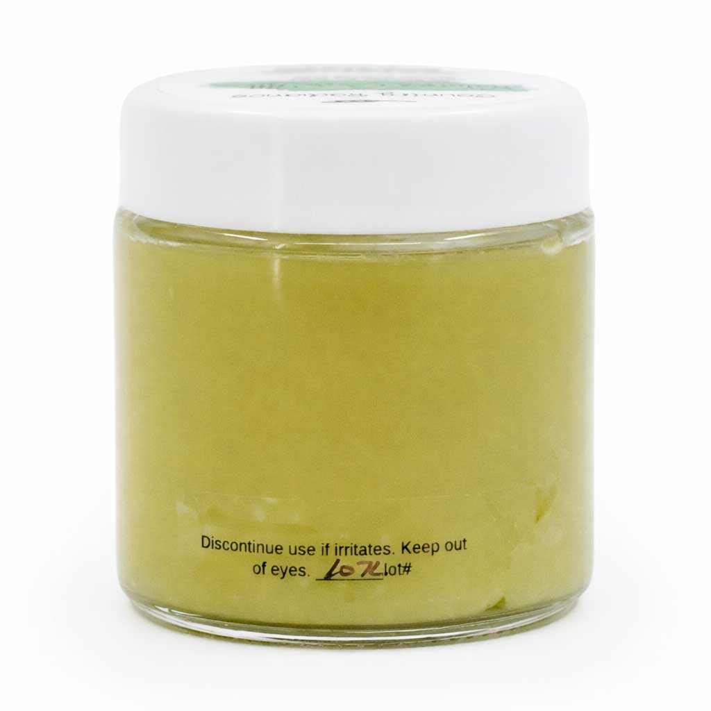 Jar of green cream with a white lid on a white background