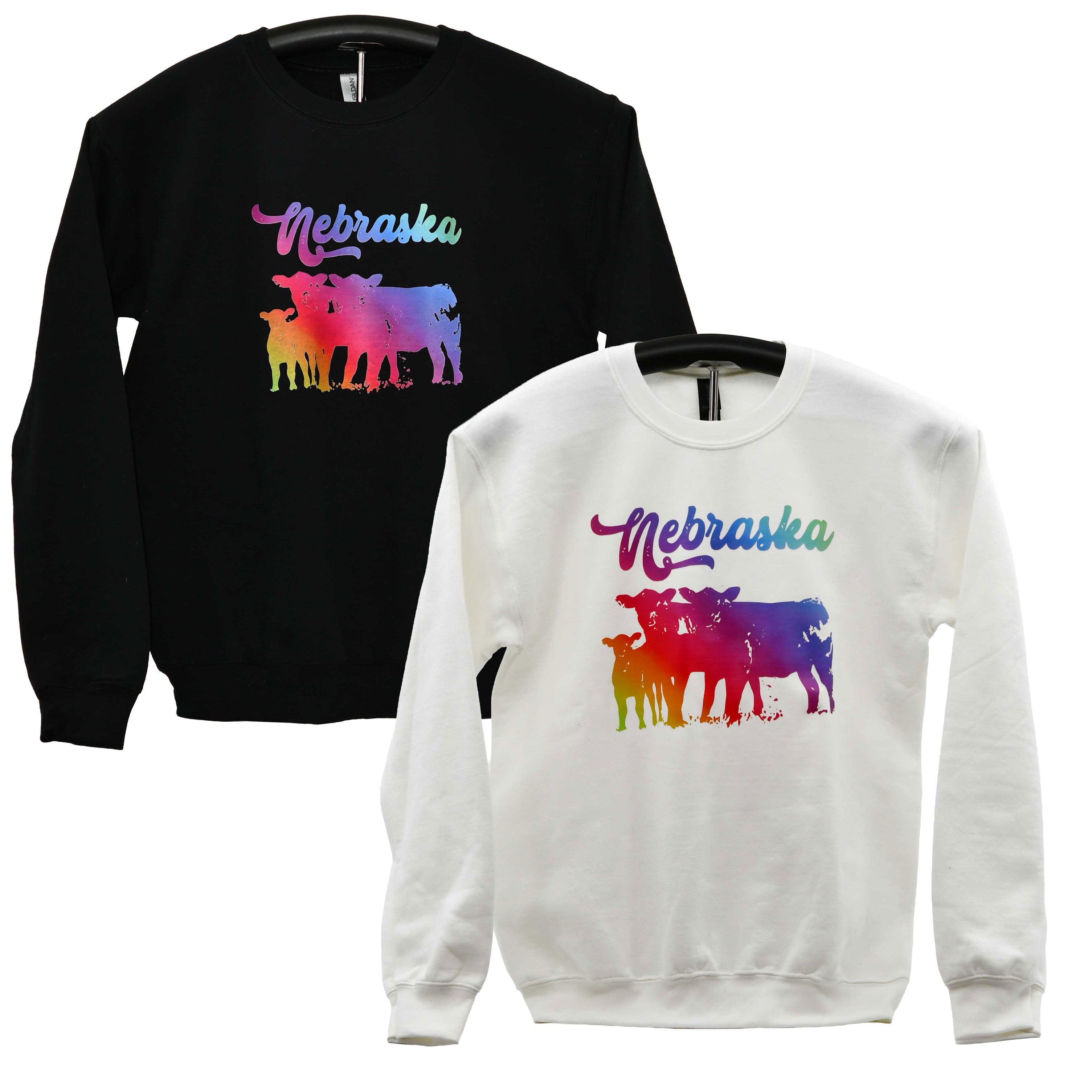 Black and white sweatshirts with colorful 'Nebraska' and cow design on hangers against a white background