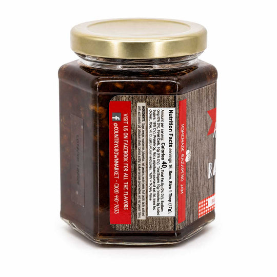 Jar of jam with a gold lid on a white background