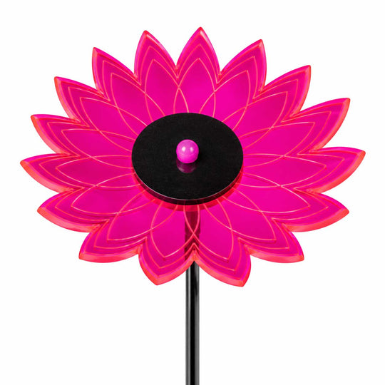 A bright pink translucent flower-shaped garden stake with a black circular center and a small pink ball, shown on a white background.