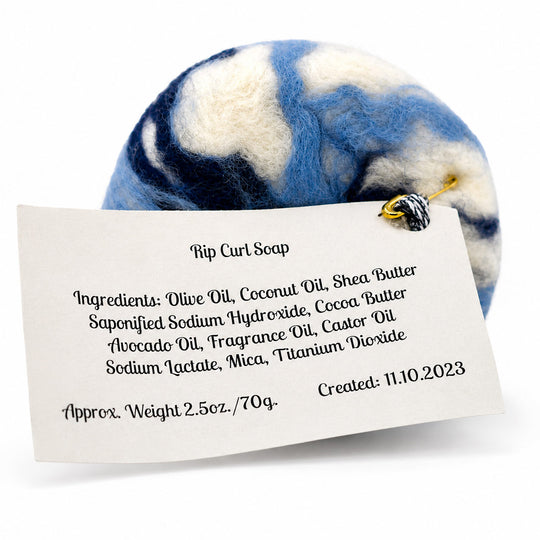 Marbled blue and white soap with a label detailing ingredients and creation date.