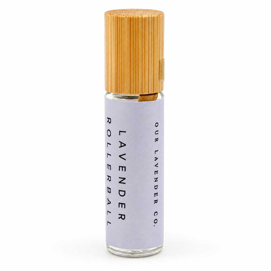 Rollerball bottle with wooden cap on a white background
