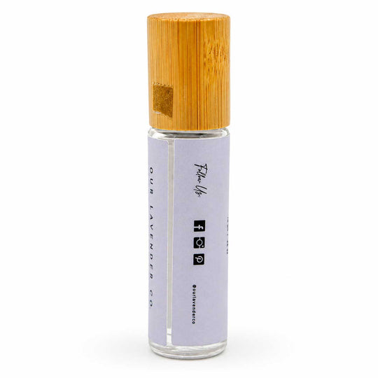 Roll-on bottle with wooden cap on a white background