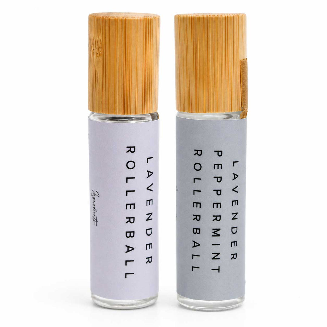Two lavender rollerball bottles with bamboo caps on a white background