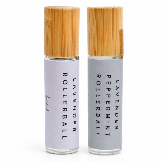 Two lavender rollerball bottles with bamboo caps on a white background