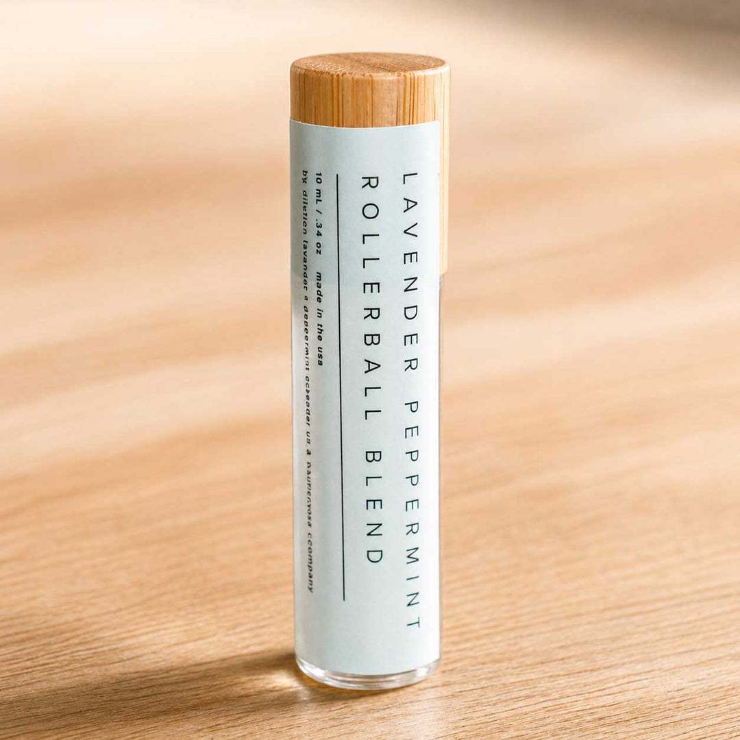 Rollerball blend bottle with wooden cap on a wooden surface