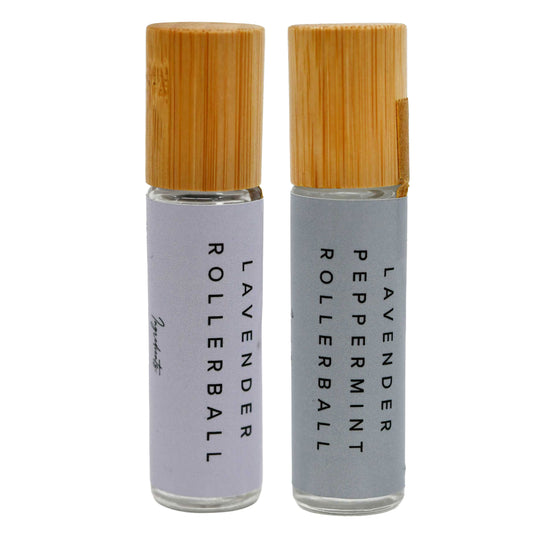 Two rollerball bottles with bamboo caps on a white background