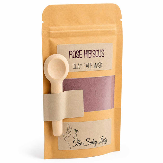 Rose Hibiscus clay face mask package with a wooden spoon on a white background