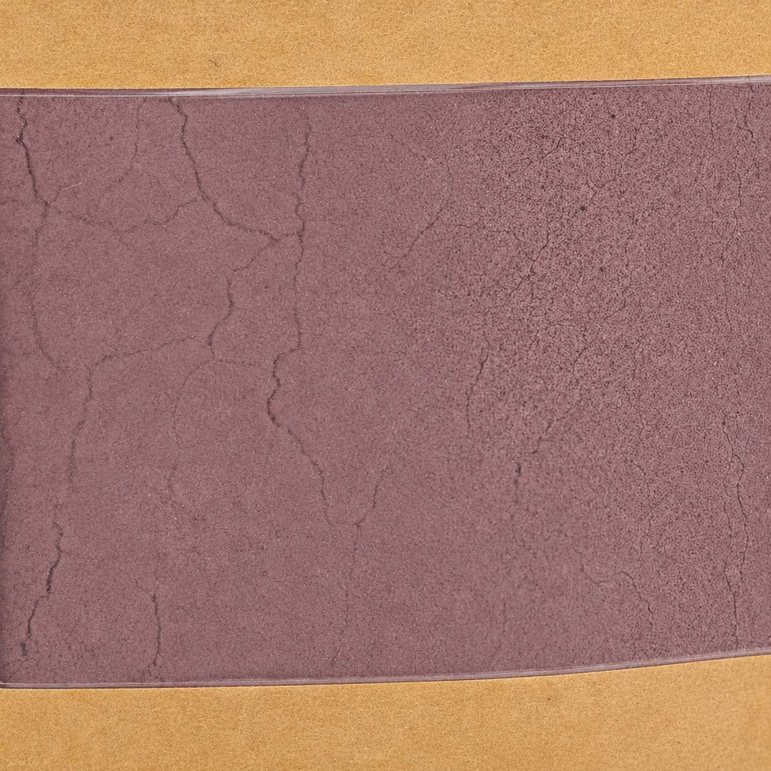 Textured purple color swatch on a yellow background