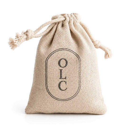 Beige drawstring bag with 'OLC' logo on a white background