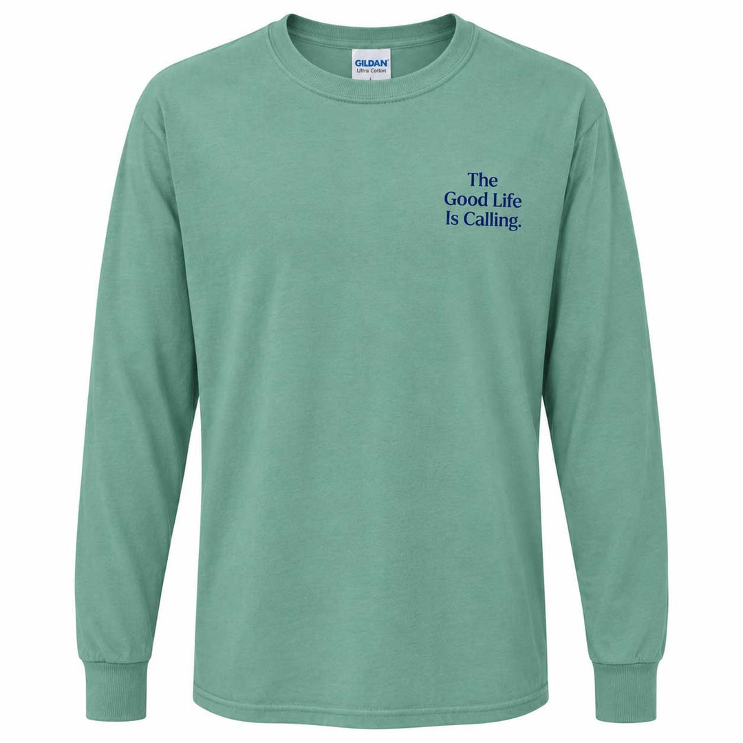 A mint green long-sleeve t-shirt with 'The Good Life Is Calling.' printed in blue text on the left chest, displayed on a clean white background.