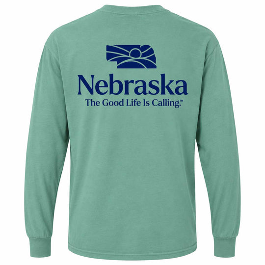 A mint green long-sleeve t-shirt shown from the back, featuring a dark blue graphic of the Nebraska state silhouette and the text 'Nebraska The Good Life Is Calling' printed on the center back.