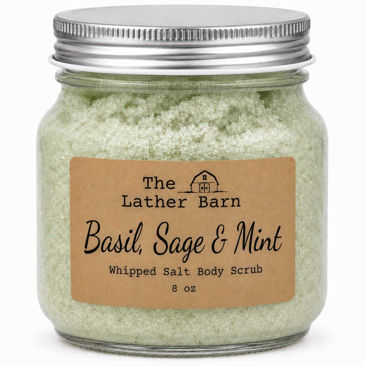 A glass jar of The Lather Barn Basil, Sage & Mint Whipped Salt Body Scrub with a brown kraft paper label and a silver metal lid, shown on a white background.