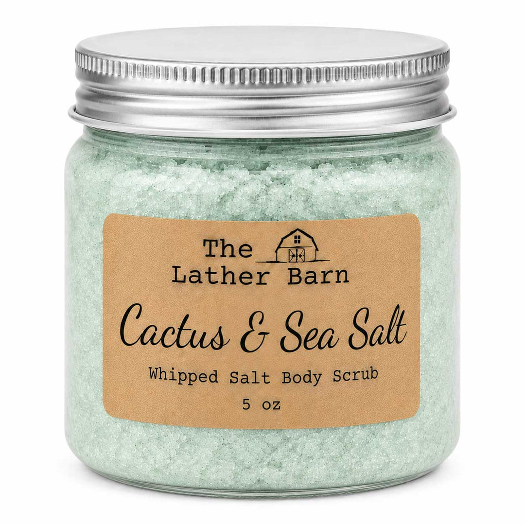 A 5 oz glass jar of The Lather Barn Cactus & Sea Salt Whipped Salt Body Scrub, filled with pale green salt crystals and topped with a silver metal lid, set against a plain white background.