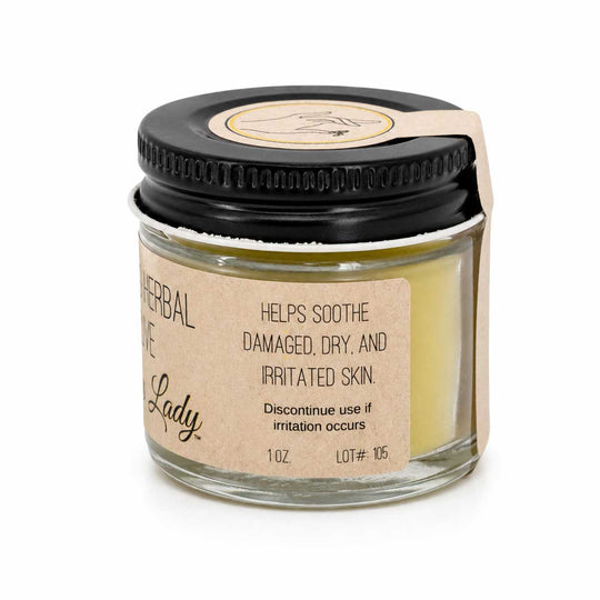 Jar of herbal balm with a black lid on a white background