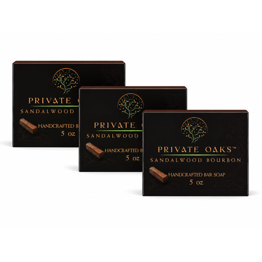 Three black rectangular boxes of Private Oaks handcrafted bar soap arranged in a fan shape on a white background. The boxes are labeled Sandalwood, Sandalwood Bourbon, and Sandalwood Bourbon 5 oz.