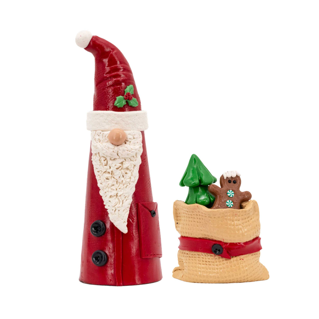 Decorative figure of a Santa Claus with a sack on a white background
