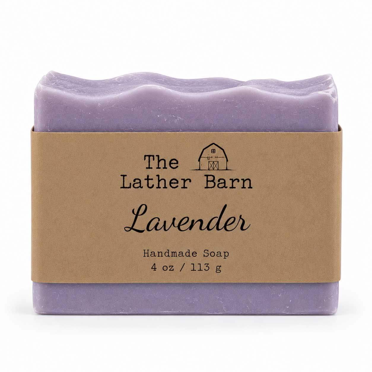 A single bar of lavender handmade soap wrapped in a kraft paper band labeled 'The Lather Barn Lavender', shown on a clean white background.