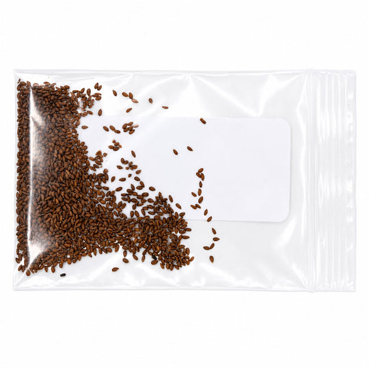 Clear plastic bag with brown seeds spilling out on a white background