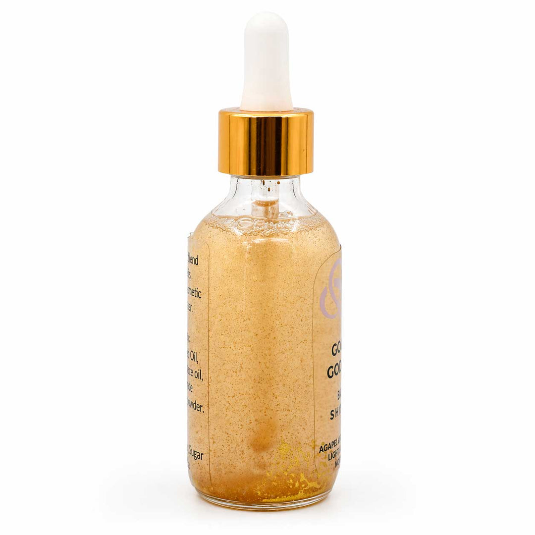 Glass dropper bottle with gold cap and gold liquid on a white background