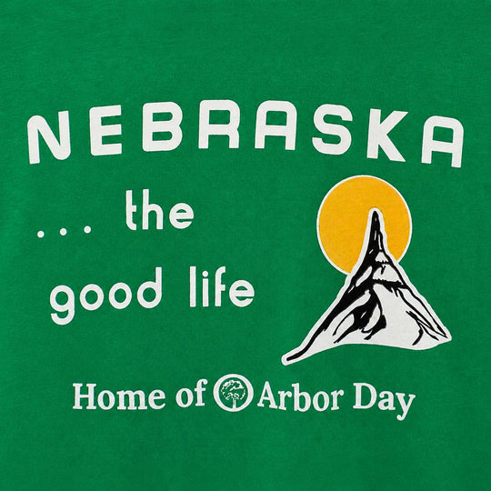 A green graphic print featuring the text 'NEBRASKA .