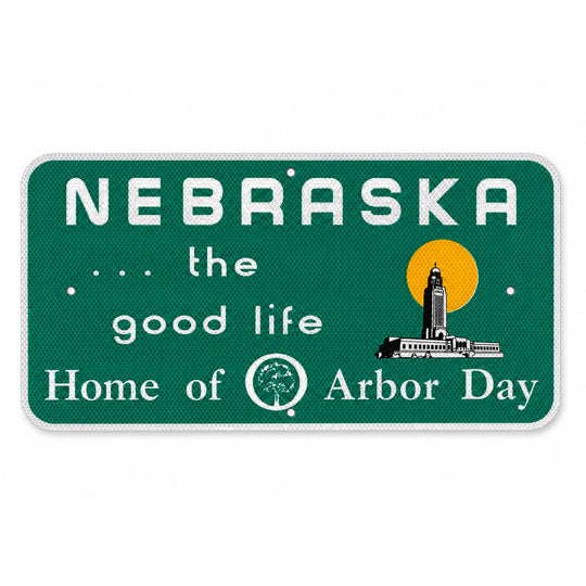 A rectangular Nebraska-themed decorative sign with rounded corners, featuring a dark green textured background, white text reading 'NEBRASKA .