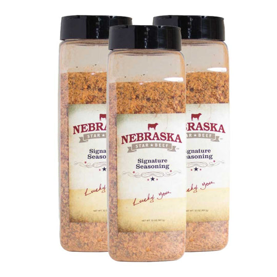 Three bottles of Nebraska Star Signature Seasoning on a white background